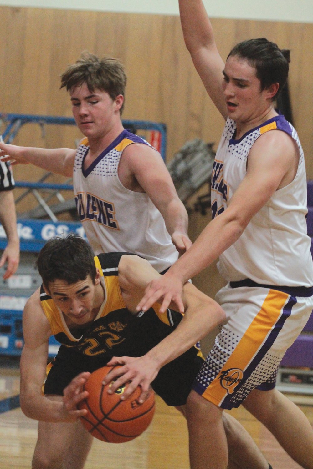 Mason Iverson and Hunter Simmons put the pressure on Clallam Bay’s William Hull during the Bruins’ matchup against the Rangers.